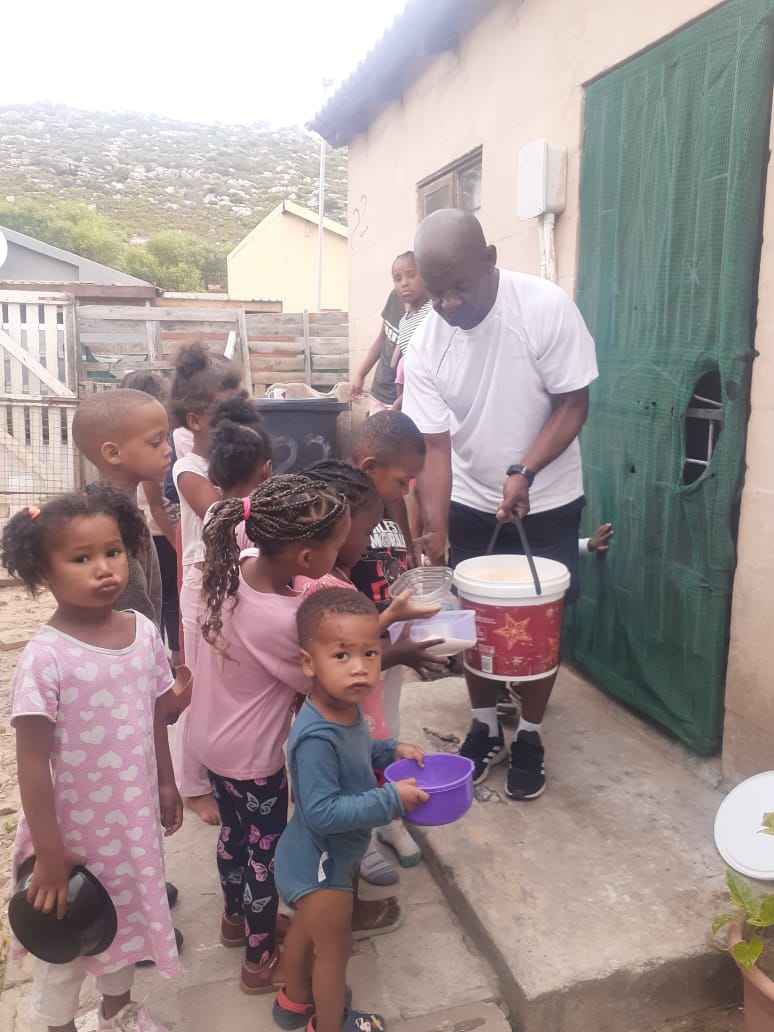Children lining up for lunch at the Ocean View Feeding Scheme