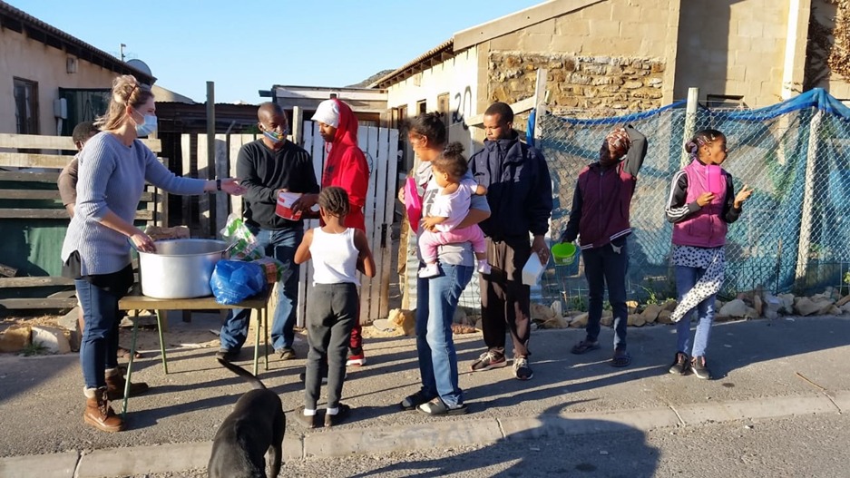 Volunteers distributing food to community members