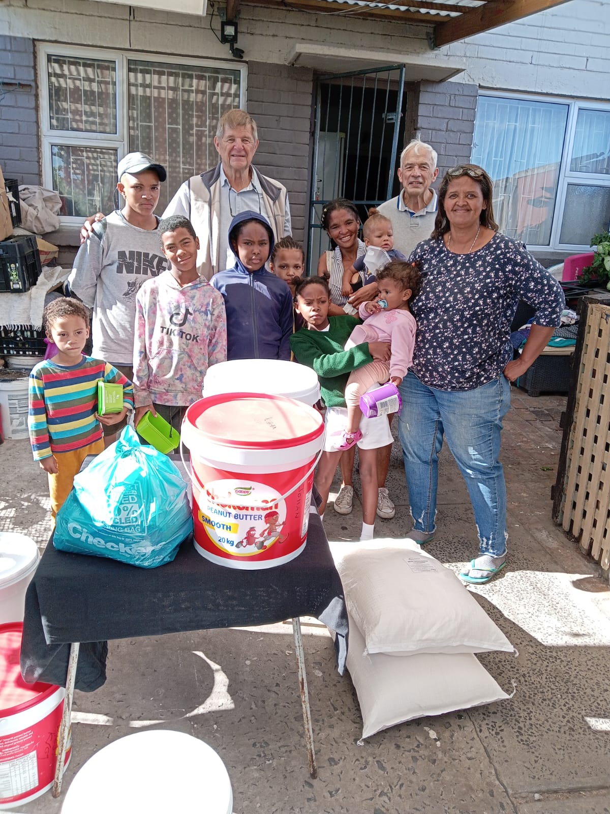 Volunteers and community members with donated food supplies